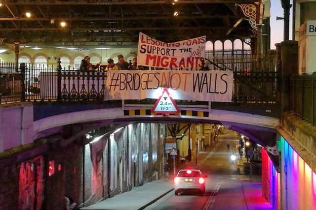 A banner unfurled in Brighton as part of the Bridges Not Walls protest against Donald Trump on the day of his inauguration.