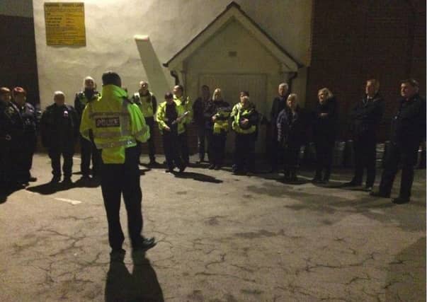 Superintendent Neil Thomas addressing officers who have been executing warrants this morning.