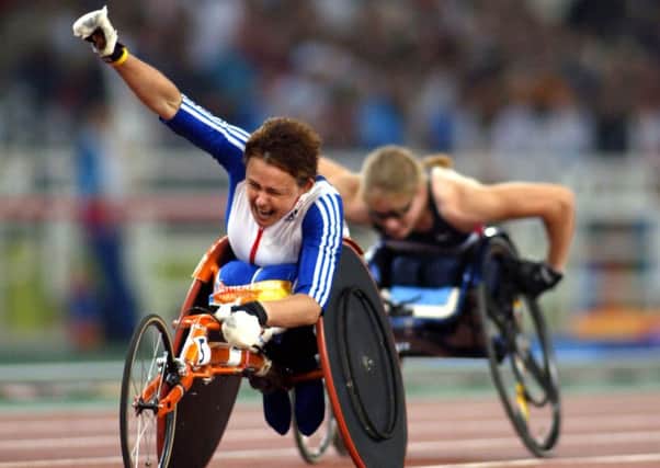 Dame Tanni Grey-Thompson celebrates one of her Paralympic gold medal wins. Picture: Gareth Copley/PA Wire.