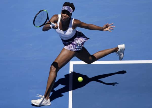 United States' Venus Williams makes a forehand return to Germany's Mona Barthel during their fourth round match at the Australian Open. (AP Photo/Dita Alangkara)