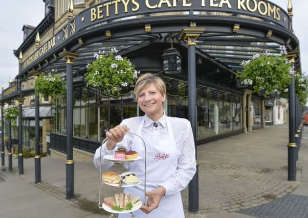 A waitress outside Bettys in Harrogate. picture mike cowling jun 16 2015