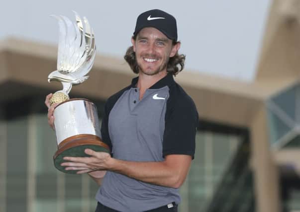 Tommy Fleetwood of England holds the trophy after he won the Abu Dhabi Golf Championship.