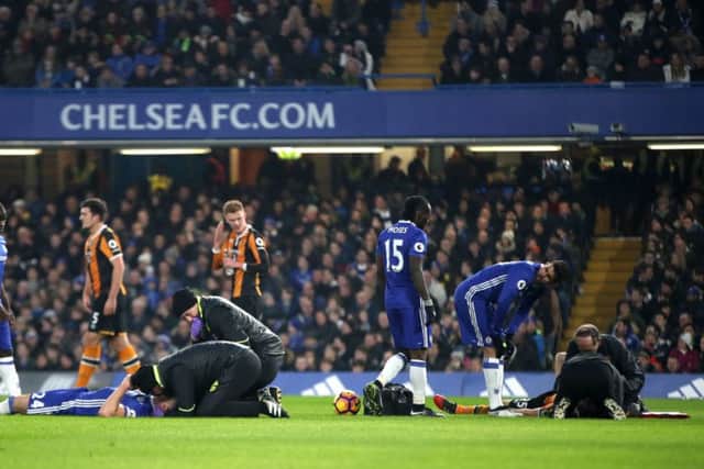 Hull City's Ryan Mason (right) and Chelsea's Gary Cahill lie injured on the floor. Picture: Nick Potts/PA