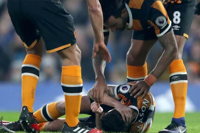 Hull City's Ryan Mason lies injured after fracturing his skull in a clash of heads with Chelsea's Gary Cahill (Picture: Nick Potts/PA Wire).