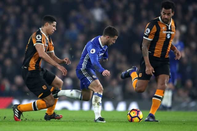 Chelsea's Eden Hazard tries to get away from Hull City's Tom Huddlestone (right) and Curtis Davies (left)
