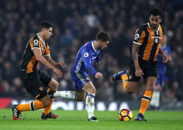 Chelsea's Eden Hazard tries to get away from Hull City's Tom Huddlestone (right) and Curtis Davies (left)