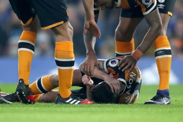 Hull City's Ryan Mason lies injured on the floor at Stamford Bridge on Sunday. Picture: Nick Potts/PA