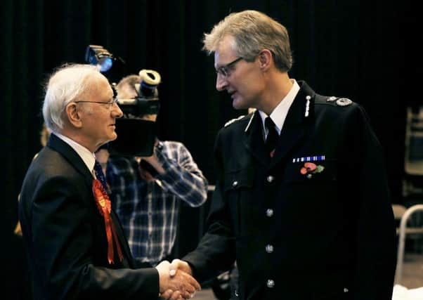 Labour Party candidate Alan Billings shakes hands with David Crompton, South Yorkshire Chief Constable (right) after winning the South Yorkshire Police and Crime Commissioner election at the Barnsley Metrodome Sports Complex, Barnsley, South Yorkshire. PRESS ASSOCIATION Photo. Picture date: Friday October 31, 2014. See PA story POLITICS PCC. Photo credit should read: Lynne Cameron/PA Wire
