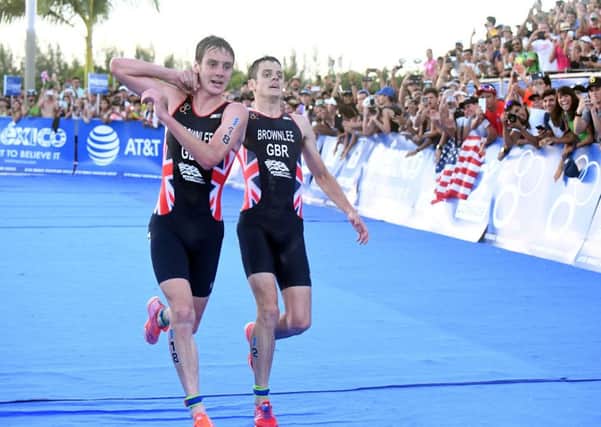 Leeds's own Alistair Brownlee, left, helps his brother Jonny to get to the finish line during the Triathlon World Series event in Cozumel, Mexico, Sunday Sept. 18, 2016  (Photo: Delly Carr via AP)