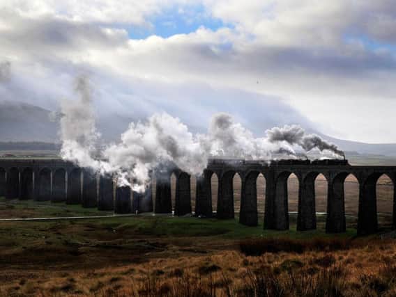 The Settle and Carlisle Railway crosses the iconic Ribblehead Viaduct.