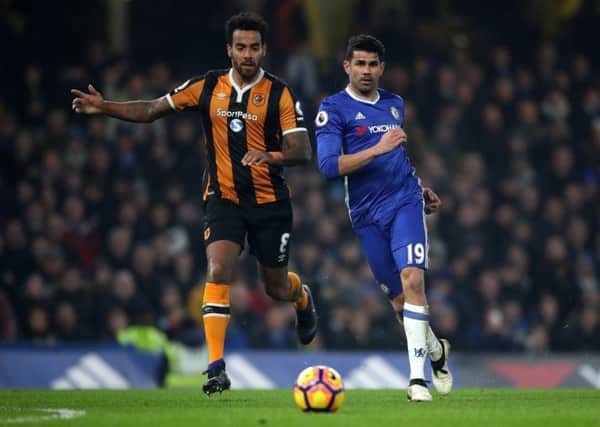 Hull City's Tom Huddlestone (left) and Chelsea's Diego Costa battle for the ball at Stamford Bridge. Picture: Nick Potts/PA