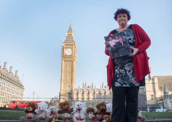 Claire Throssell, whose children were killed by her abusive ex-husband in 2014, lays 20 teddy bears in Westminster symbolising the children who have died as a result of unsafe child contact with a parent who is a perpetrator of domestic abuse, after she delivered a petition to Downing Street. PRESS ASSOCIATION Photo. Picture date: Tuesday January 24, 2017. See PA story POLITICS Violence. Photo credit should read: Stefan Rousseau/PA Wire