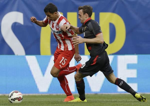 Flashback: Olympiacos defender Omar Elabdellaoui, left, controls the ball against Liverpool defender Jack Robinson.