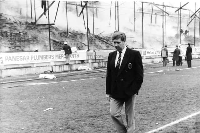 Bradford, Valley Parade, 11th May 1985  Bradford City chairman, Mr. Stafford Heginbotham,  wanders disconsulate and in a daze past the gutted stand.