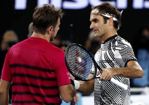 Switzerland's Roger Federer, right, is congratulated by compatriot Stan Wawrinka (AP Photo/Kin Cheung)