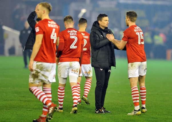 Tykes boss Paul Heckingbottom congratulates his players after beating Leeds 3-2.