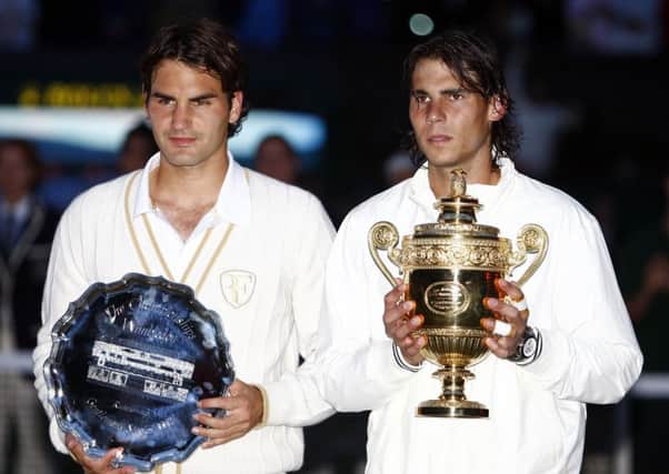 Spain's Rafael Nadal (right) and Switzerland's Roger Federer with their trophies following the Men's Final during the Wimbledon Championships 2008.