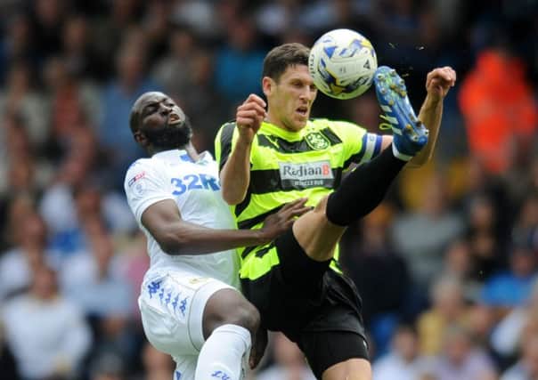Leeds United's Souleymane Doukara challenges Town's Mark Hudson.