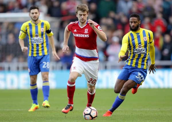 Middlesbrough's Patrick Bamford (centre) and Accrington Stanley's Janoi Donacien (right) battle for the ball.