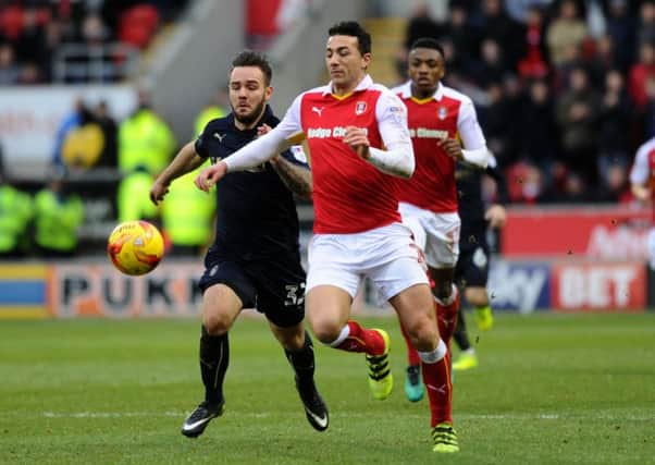 Rotherham's Stephen Kelly challenges Barnsley's Adam Armstrong.  Picture: Jonathan Gawthorpe