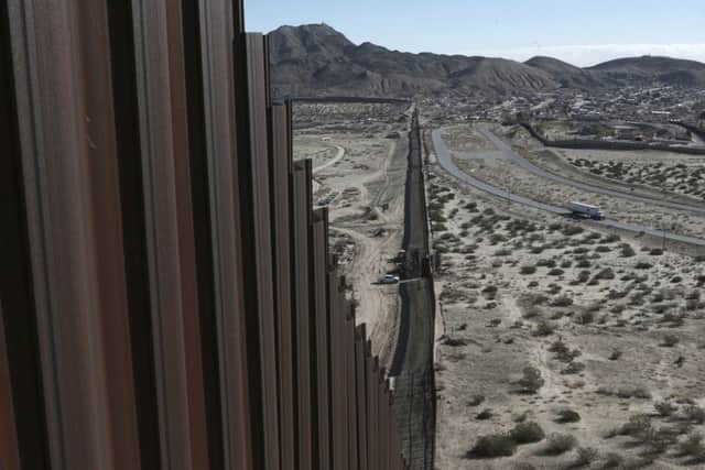 A truck drives near the Mexico-US border fence, on the Mexican side, separating the towns of Anapra, Mexico and Sunland Park, New Mexico, Wednesday, Jan. 25, 2017.  U.S. President Donald Trump will direct the Homeland Security Department to start building a wall at the Mexican border. (AP Photo/Christian Torres)