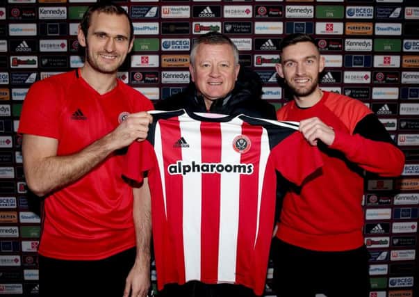 Welcome aboard: Sheffield United manager Chris Wilder, centre, made a number of key signings, including James Hanson, left, from Bradford City, and Jay OShea, right, Chesterfield. (Picture: Sport Image)