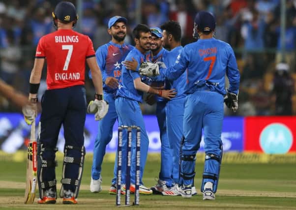 India's Yuzvendra Chahal, third left, celebrates with teammates the dismissal of England's Sam Billings, left, during their third Twenty20 international cricket match at Chinnaswamy Stadium in Bangalore. (AP Photo/Aijaz Rahi)