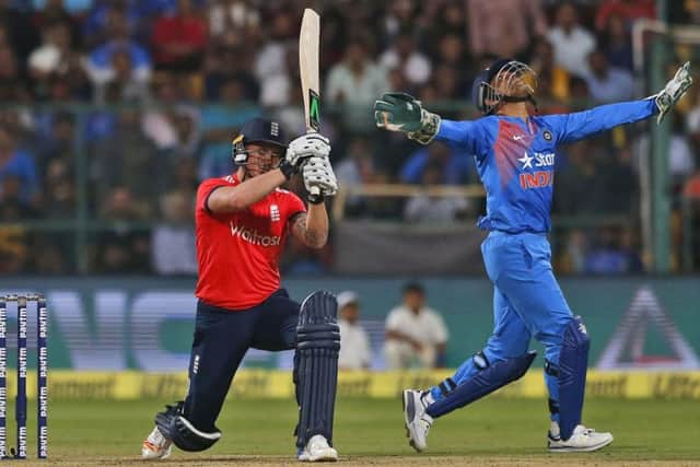 India's wicketkeeper Mahendra Singh Dhoni, right, stretches his arms to catch the ball to dismiss England's Jason Roy. (AP Photo/Aijaz Rahi)