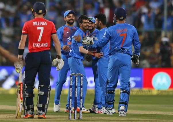 India's Yuzvendra Chahal, third left, celebrates with teammates the dismissal of England's Sam Billings, left.