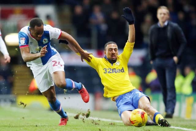 Blackburn Rovers' Ryan Nyambe (left) and Leeds United's Kemar Roofe battle for the ball.