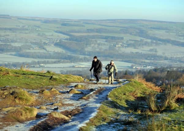 29 December 2016.......  Walkers make their way onto Ilkley Moor past the Cow and Calf in Ilkley as a sharp frost hit the region. Picture Tony Johnson.
