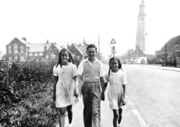 1950s Withernsea-born film star Kay Kendall as a child, right, walking past Withernsea lighthouse with her older brother and sister, Terry and Kim.