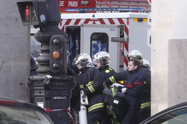 Rescue workers carry a stretcher outside the Louvre museum in Paris