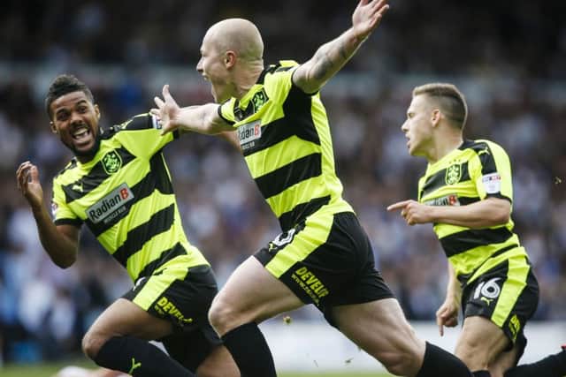 Huddersfield Town's Aaron Mooy (centre) celebrates scoring his sides first goal during the Sky Bet Championship match at Elland Road, Leeds, earlier this season.