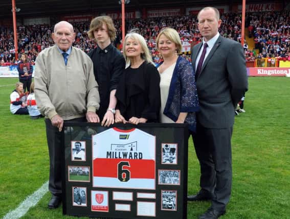Colin Hutton, left, presenting a signed Hull KR shirt to the wife of Roger Millward, Carol