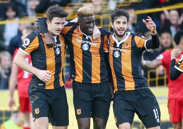 Hull City's Alfred N'Diaye, centre, celebrates scoring his side's first goal in the 2-0 defeat of Liverpool (Picture: Danny Lawson/PA Wire).