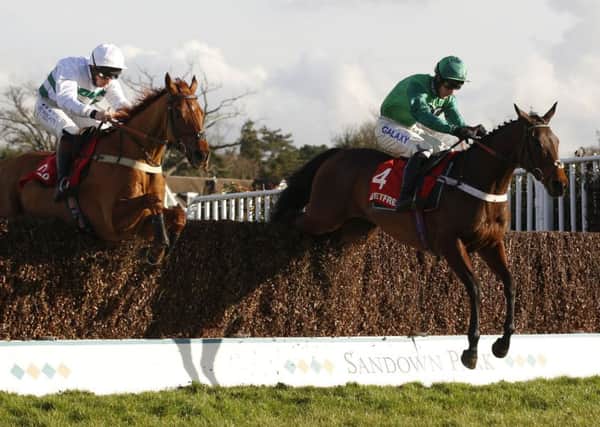 Top Notch ridden by Daryl Jacob leads Baron Alco ridden by Jamie Moore over the last fence.