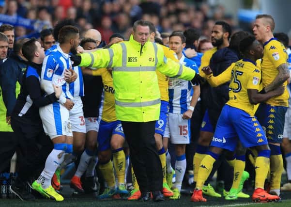 A steward attempts to separate Huddersfield Town and Leeds United players after a melee that marred the Championship derby at John Smiths Stadium, won 2-1 by the hosts (Picture:Nigel French/PA Wire)