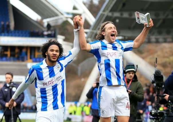 Huddersfield Town goalscorers Izzy Brown and Michael Hefele salute the fans at the end of the win over Leeds United (Picture: PA).