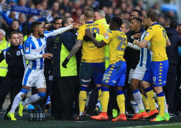 Tempers flare between Huddersfield Town and Leeds United players and staff at the John Smith's Stadium on Sunday (Picture: Nigel French/PA Wire).