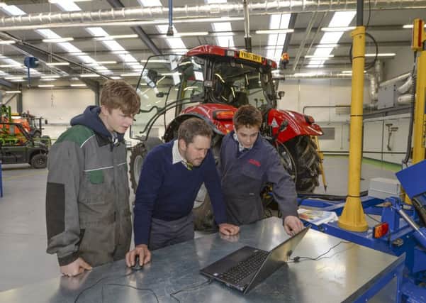 Engineering students Calum Spink and Oliver Small with lecturer Nigel Crosby (centre) at the opening of Askham Bryan College's new Â£2.4m agriculture and land based engineering hub, the Lance Gilling Building.   Picture: Mike Cowling.