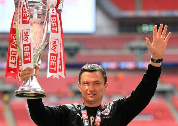 Barnsley manager Paul Heckingbottom holds aloft the League One play-off final  trophy (Picture: Nigel French/PA Wire).
