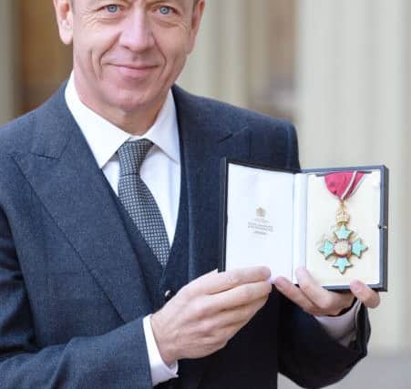 Screenwriter Peter Morgan with his Commander of the British Empire (CBE) medal which was presented to him last year. John Stillwell/PA Wire.