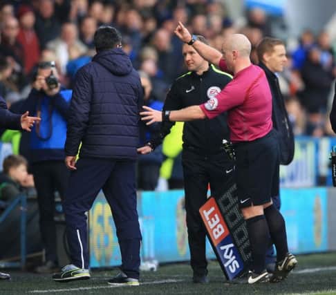 Huddersfield Town manager David Wagner (left) is sent to the stand by referee Simon Hooper.