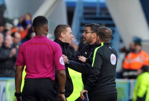 FLASHPOINT: Garry Monk confronts counterpart David Wagner after he celebrated his teams winner on the pitch with the players. Picture: Tony Johnson.
