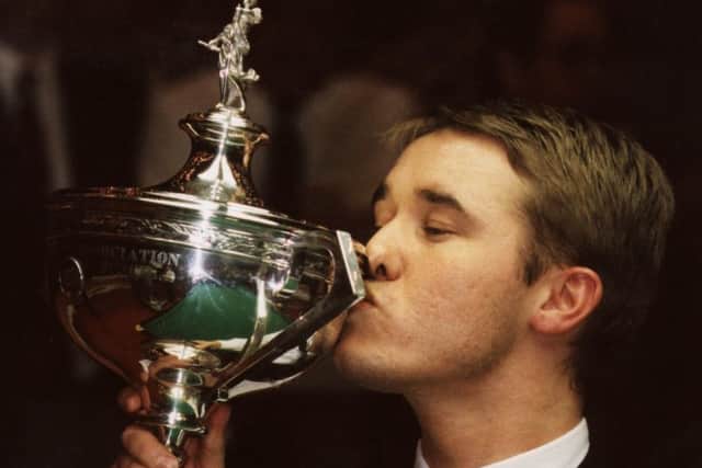Stephen Hendry celebrates winning one of his seven world snooker titles.