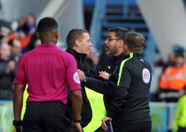 Leeds boss Garry Monk confronts counterpart David Wagner on Sunday. Picture: Tony Johnson.