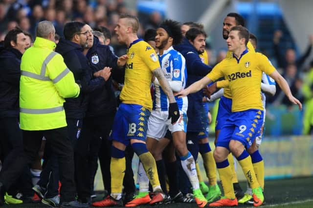 Huddersfield Town manager David Wagner (left) and Leeds United's Pontus Jansson (centre) confront each other on Sunday. Picture: Nigel French/PA