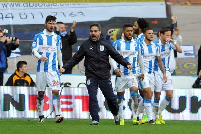 Huddersfield Town boss David Wagner celebrates his team's late winner against Leeds with his players - it caused a spot of bother shortly after. Picture: Tony Johnson.