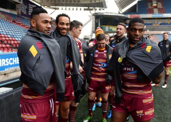 WARMING UP: Huddersfield Giants' Ukuma Ta'ai, left, Leroy Cudjoe and Jermaine McGillvary trying to keep warm at the club's press day last month.  Picture: Bruce Rollinson